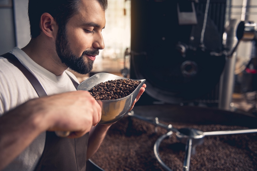 Man smelling roasted coffee beans - Gridlock Coffee Roasters